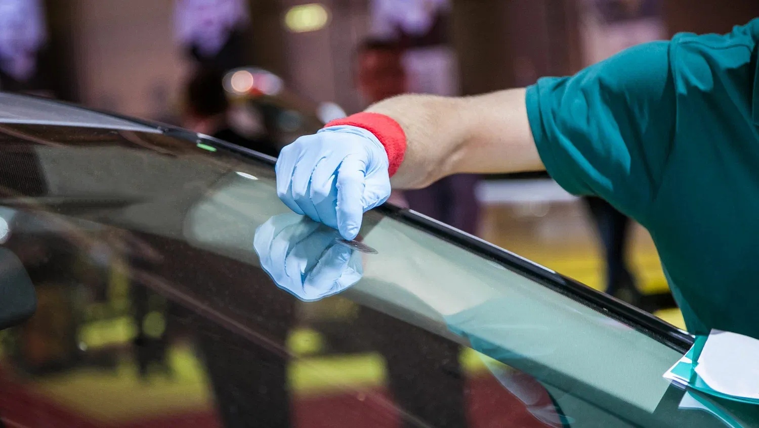 Glass Inc technician repairing car glass