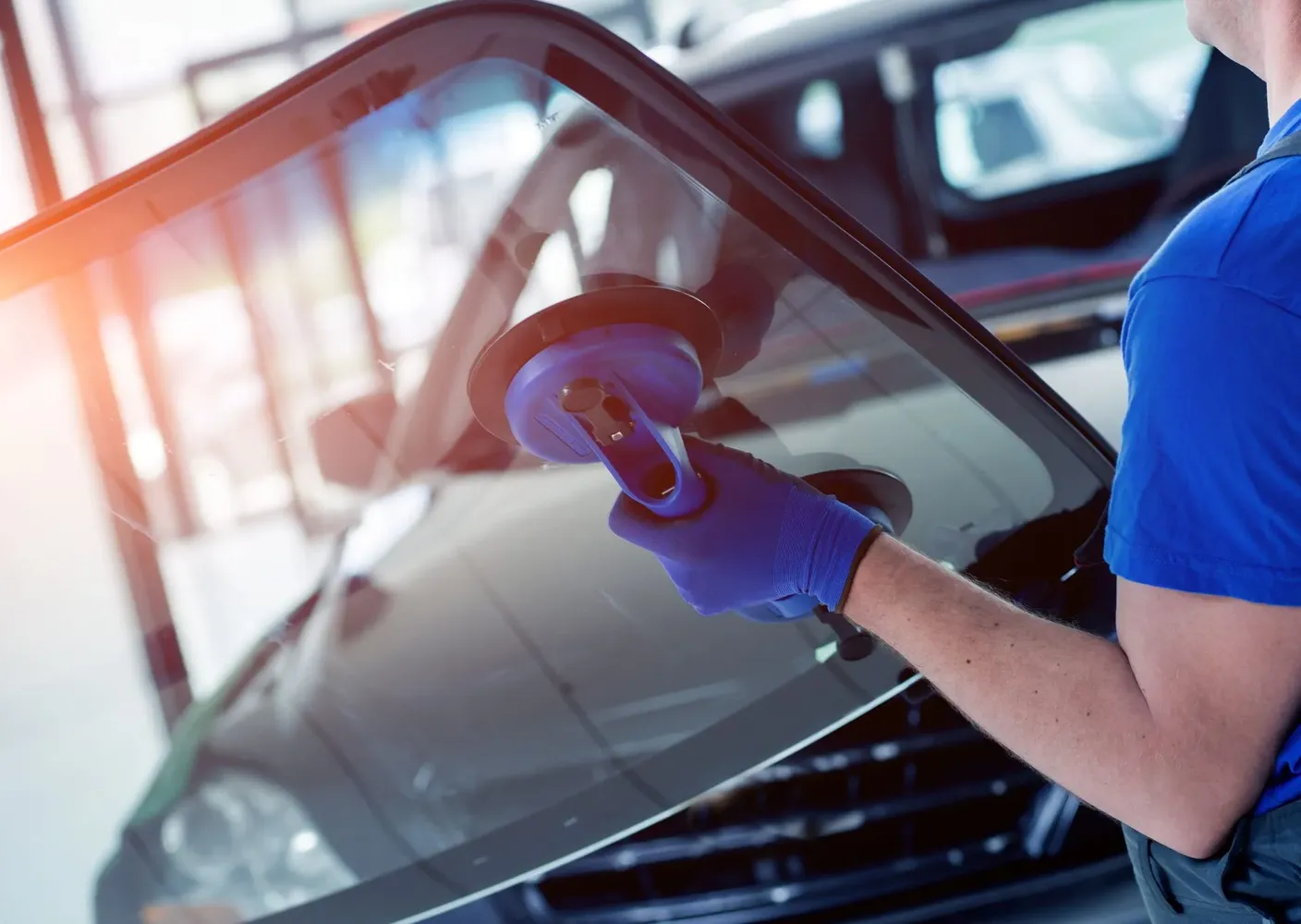 Glass Inc technician replacing a windshield