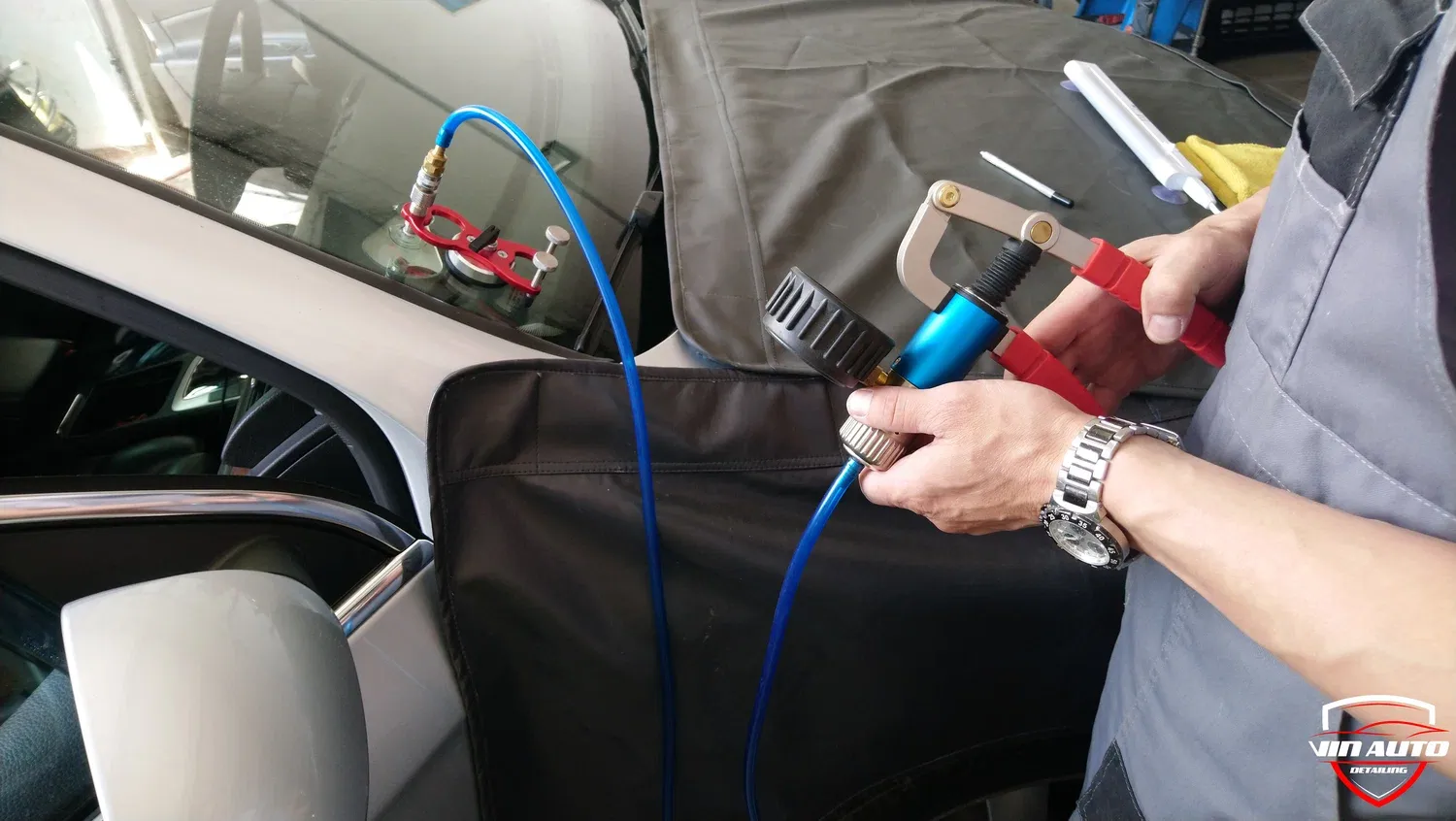 Technician performing mobile auto glass repair